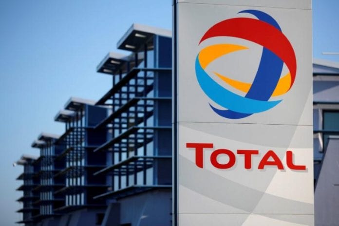 FILE PHOTO: The logo of French oil giant Total is seen in front of the oil refinery of Donges