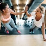 Two attractive fitness girls doing push ups